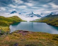Dramatic summer view of Bachsee lake with Wetterhorn and Wellhorn peaks on background. Royalty Free Stock Photo