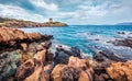 Dramatic summer view of Piscinni bay with Torre di Pixinni tower on background. Splendid morning scene of Sardinia island, Italy,