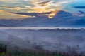 Dramatic Sunrise with Early Morning Mist over Forested Valley at Altai Mountains, Kazakhstan. Fantasyland, Blue Hour Concept Royalty Free Stock Photo