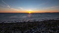 dramatic sunrise over the baltic sea with rocky beach and trees Royalty Free Stock Photo