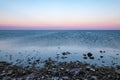 dramatic sunrise over the baltic sea with rocky beach and trees Royalty Free Stock Photo