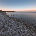 dramatic sunrise over the baltic sea with rocky beach and trees Royalty Free Stock Photo