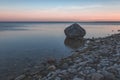 dramatic sunrise over the baltic sea with rocky beach and trees Royalty Free Stock Photo