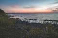 dramatic sunrise over the baltic sea with rocky beach and trees Royalty Free Stock Photo