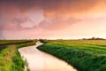 Dramatic sunrise over canal in farmland Royalty Free Stock Photo