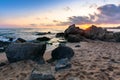 Waves crashing rocks on sandy beach. beautiful cloudscape above the horizon