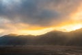 Dramatic sunset as last light pass through the mountain range in Bromo Tengger Semeru National Park, East Java, Indonesia