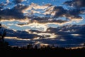Scenery. Dramatic sunset on the background of the forest. The last rays of the sun break through heavy thunderclouds Royalty Free Stock Photo