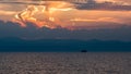 Dramatic sunset behind clouds over sea Royalty Free Stock Photo