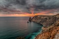 Dramatic sunset on cliffs seascape with the rays of the sun burning through menacing clouds, hdr cape Fiolent Crimea Royalty Free Stock Photo