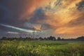 Dramatic Sunset Clouds over Green Countryside Fields Royalty Free Stock Photo