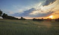 Dramatic Sunset Clouds over Green Countryside Fields Royalty Free Stock Photo