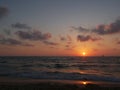 Dramatic sunset with clouds over mediterranean sea, yacht and ship on horizon, Tel Aviv, Israel. Royalty Free Stock Photo