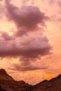 Dramatic sunset with clouds over rocky hillocks