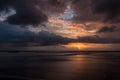 Dramatic sunset clouds reflected on the water sea. Tropical beach landscape Royalty Free Stock Photo