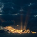 Dramatic sunset with dark clouds and glimpses of light. Royalty Free Stock Photo