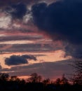 Dramatic sunset with dark clouds and glimpses of light. Royalty Free Stock Photo