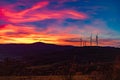 Dramatic Sunset Landscape with Wind Turbines Silhouette HDR Royalty Free Stock Photo