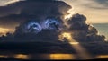 Dramatic sunset with lightning striking through dark storm clouds thunder Royalty Free Stock Photo