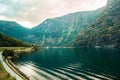 Dramatic sunset in the mountains above the fjord of Norway. Beautiful view with reflection in the water