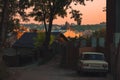 Dramatic sunset on old city Lviv back street outskirts district with USSR car foreground space and medieval historical center Royalty Free Stock Photo