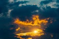 Dramatic sunset with orange and blue colored clouds in the sky. Royalty Free Stock Photo