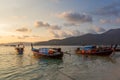 Dramatic sunset over Beach at Lipe Island, Thailand, with traditional longtail boat in the foreground. Royalty Free Stock Photo