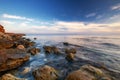 Dramatic sunset over beach with a natural pond in the foreground Royalty Free Stock Photo