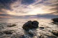 Dramatic sunset over beach with a natural pond in the foreground Royalty Free Stock Photo