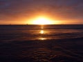 Dramatic Sunset over the clouds and reflecting on the Pacific ocean on the water of Waikiki Royalty Free Stock Photo