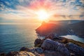 Dramatic sunset over Crimean rock cliff, beautiful sea nature landscape, summer travel and freedom Royalty Free Stock Photo