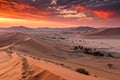 Dramatic sunset over desert dunes and landscape Royalty Free Stock Photo