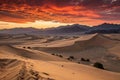 Dramatic sunset over desert dunes and mountains Royalty Free Stock Photo
