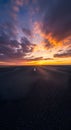 Dramatic sunset over empty highway with vibrant orange clouds Royalty Free Stock Photo
