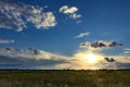 Dramatic sunset over fields with clouds during late summer Royalty Free Stock Photo