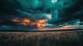 Dramatic Sunset Over Fields Surrounded by Dark Clouds and Warm Colors in the Sky Royalty Free Stock Photo