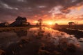 dramatic sunset over flood-affected farmland