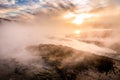 Dramatic sunset over foggy wetland of geyser basin, Snake river, Yellowstone