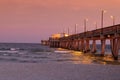 Dramatic sunset over the Gulf State Park Pier silhouetting a picturesque shoreline