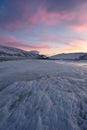 Dramatic sunset over the icy lake in the Arctic tundra. Yamal peninsula.