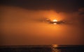 Dramatic sunset over the ocean. Cloudy and orange sky. Beautiful end of day Royalty Free Stock Photo