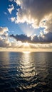 Dramatic sunset over ocean with sun rays breaking through clouds Royalty Free Stock Photo