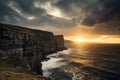 dramatic sunset over a rugged coastal cliff, with the sun peeking out from behind the clouds Royalty Free Stock Photo