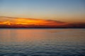 dramatic sunset over sea beach with rocks and stormy water Royalty Free Stock Photo