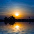 Dramatic sunset over the small quiet lake