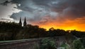 Dramatic sunset over Vysehrad hill with cathedral. Royalty Free Stock Photo