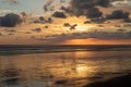 Dramatic Sunset with Relections on a sandy beach