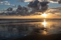 Dramatic Sunset with Relections on a sandy beach