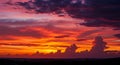 Dramatic sunset scene featuring an array of vivid colors, including deep purples, Royalty Free Stock Photo