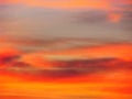 Dramatic sunset sky background with fiery clouds, yellow, orange and pink colors Royalty Free Stock Photo